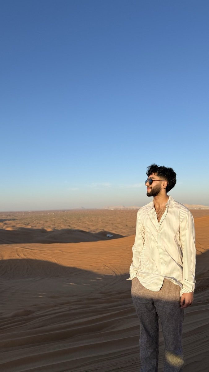 Rehan Hashim standing on a sand dune